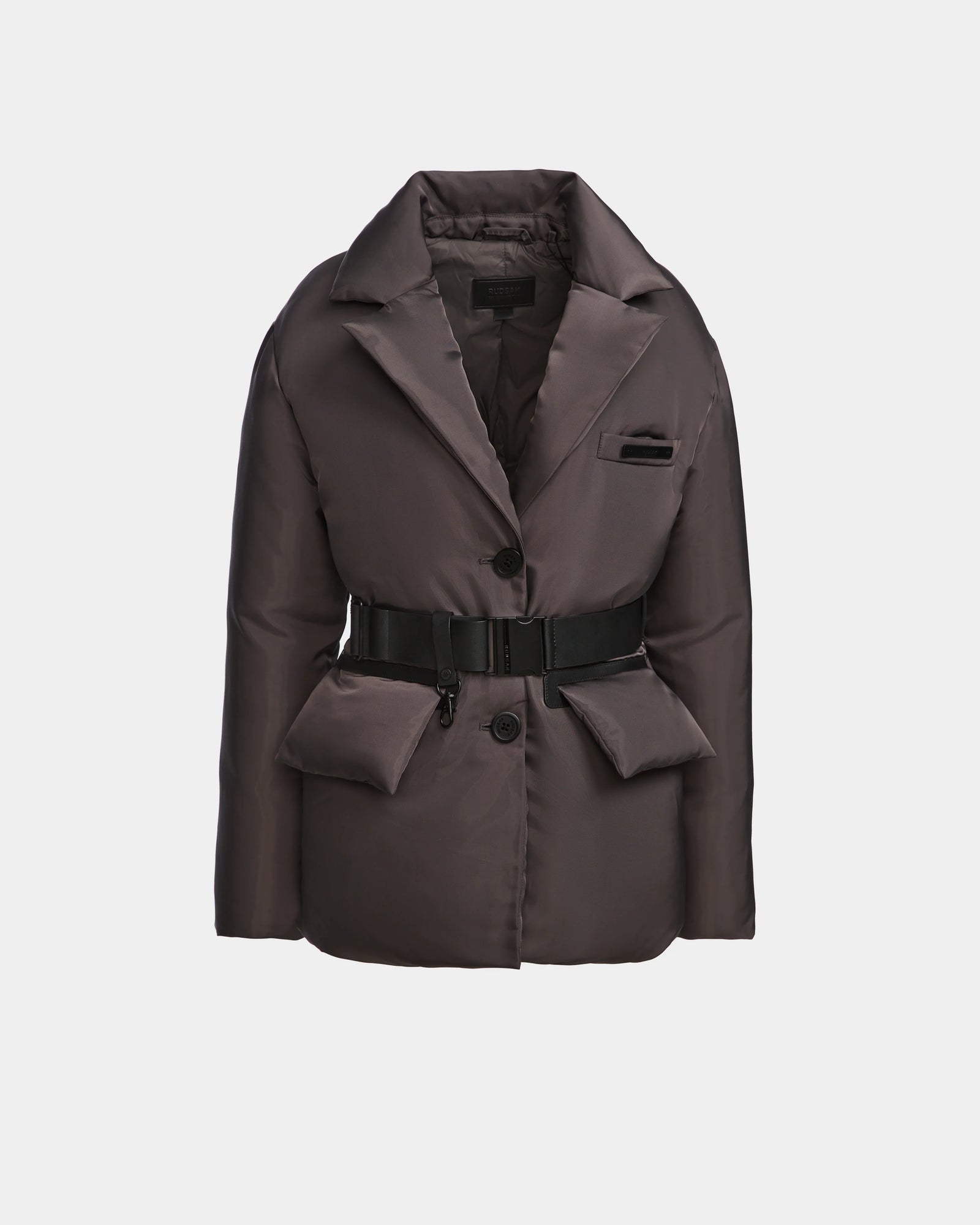 The PAOLA - 8124547 Grey by Rudsak is a womens down blazer with RDS-certified down, notched collar, button closure, two large front pockets, a small chest pocket, and a black belt at the waist, shown against a plain light background.