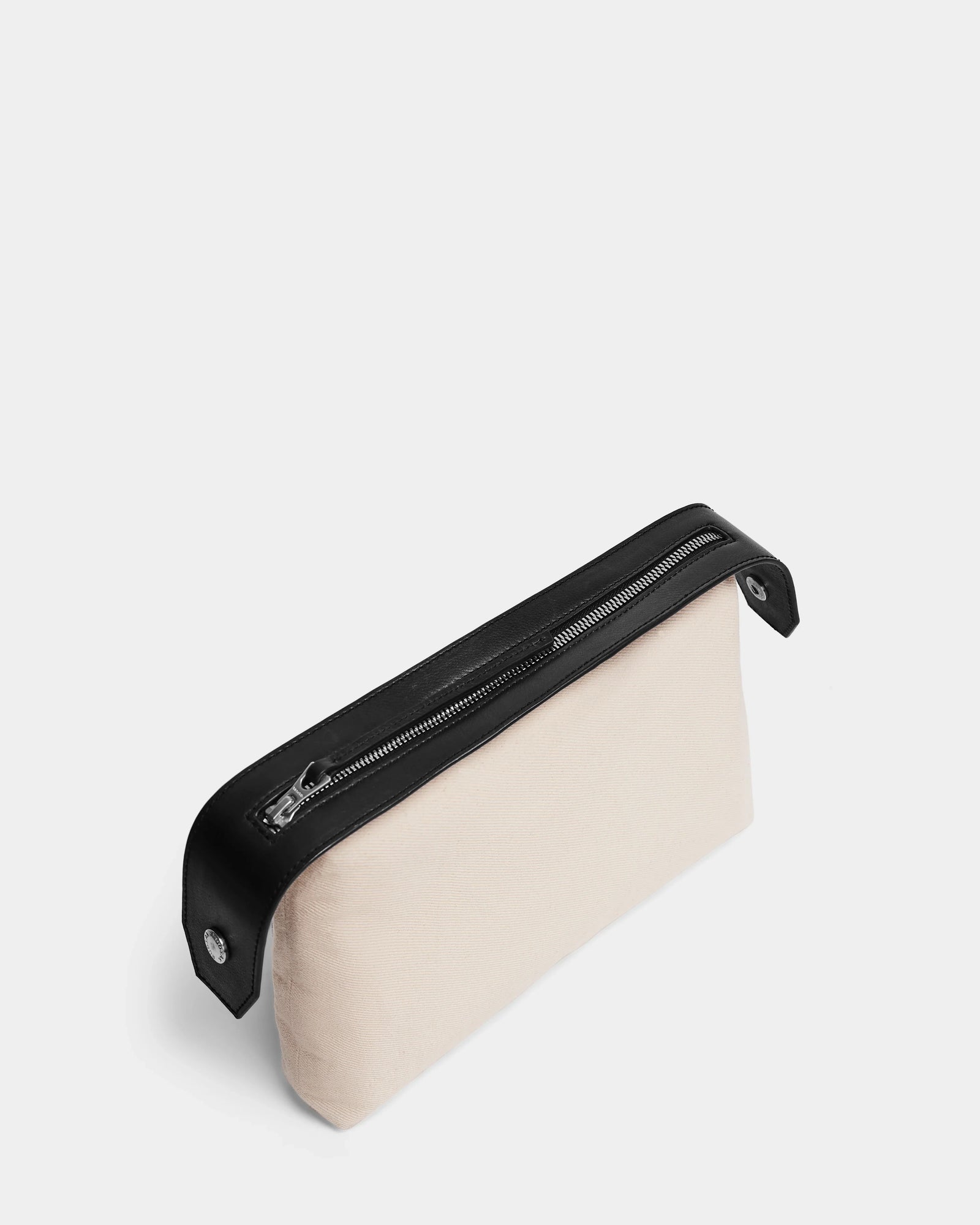 A rectangular black YASMINA - 8324527 pouch by Rudsak, featuring a sleek zipper and trim, is photographed on a plain white background—an elegant accessory to pair with any Rudsak leather tote.