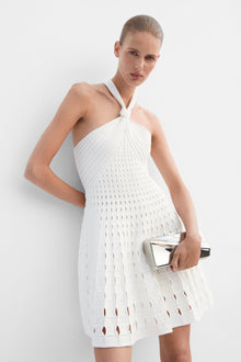 White halter mini dress with eyelet knit texture and cutout details throughout.