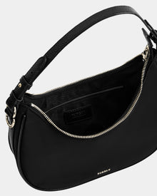 The Rudsak NIKKI - L325512 Black is a sleek women's black leather crescent shoulder bag with gold zipper, adjustable strap, inner pocket with stitched label, a hobo silhouette, and a fabric-lined interior.