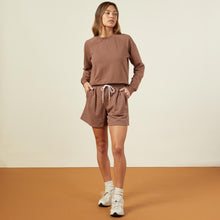 Front view of model wearing the 90's classic sweat short in dusty cocoa.