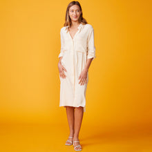 Front view of model wearing the linen shirt dress in buttercream.