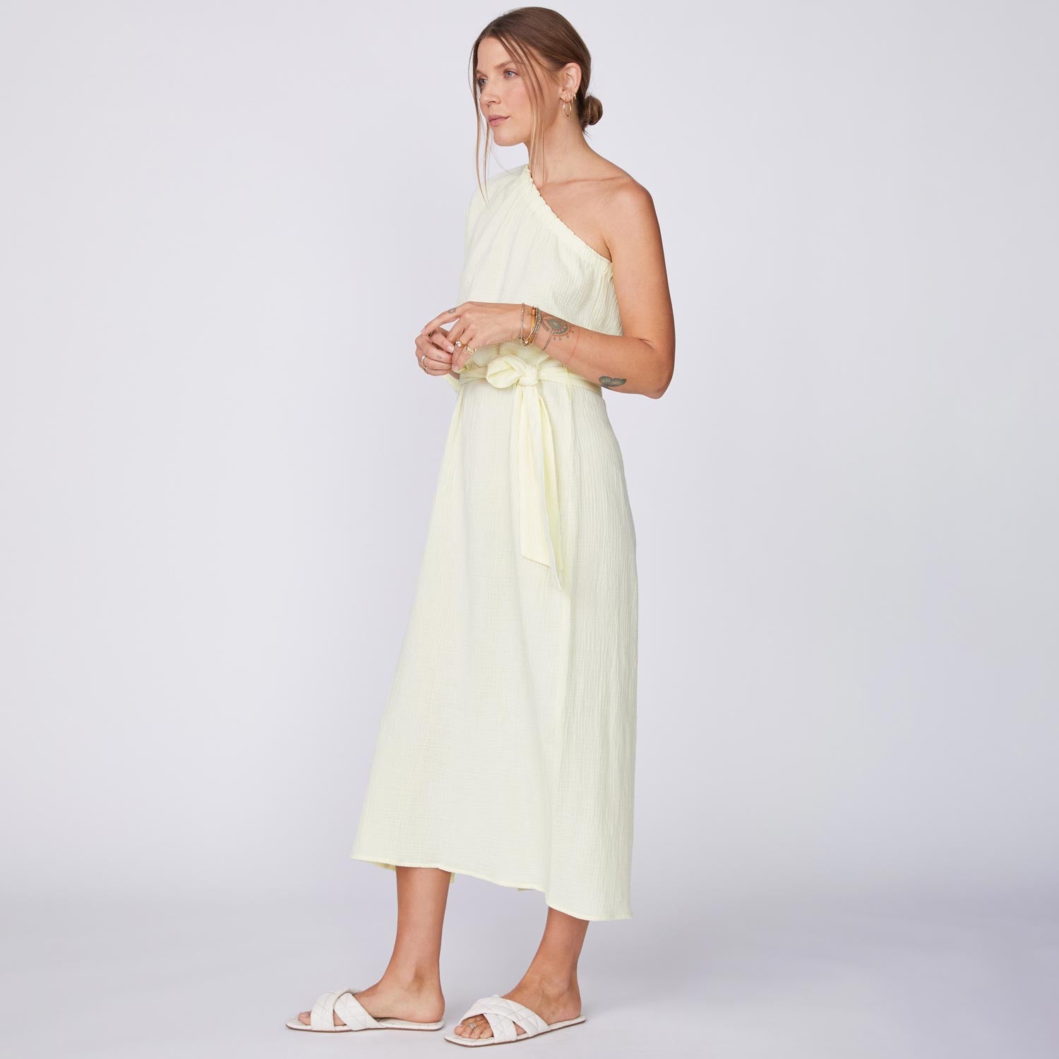 Side View of Model wearing the Gauze One Shoulder Dress in Lemon