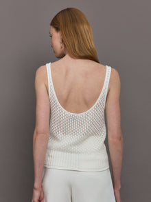 Model wears a white knit wide neck mesh patterned tank.