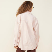 Back view of model wearing the corduroy shacket in light taupe.