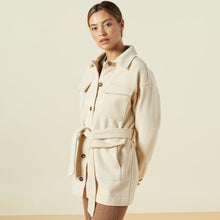 Side view of model wearing the safari jacket in off white.