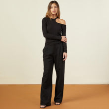 Front view of model wearing the flat rib asymmetric long sleeve in black.