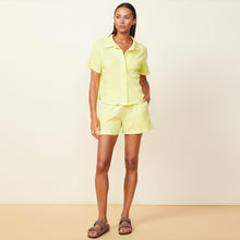 Front view of model wearing the baby thermal vacation shorts in citron.