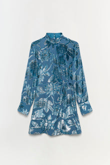Blue mini dress with silver leaf print, long sleeves, gathered neckline, and gathered waist detail.