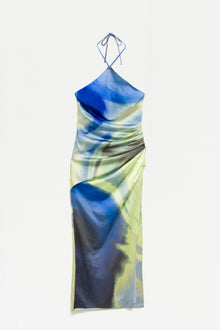 Halter gown with blue, yellow, and gray tie-dye print and ruched side detailing.