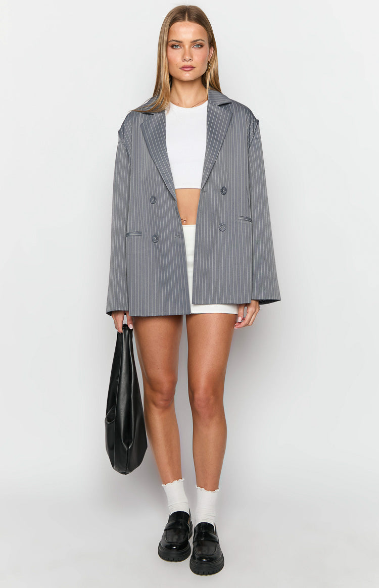 Front view of a grey pinstripe oversized blazer with notched lapels and double-breasted button closure