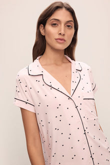 Model is wearing Gisele Printed TENCEL Modal Shortie Short PJ Set in Little Heart Sorbet Pink/Black