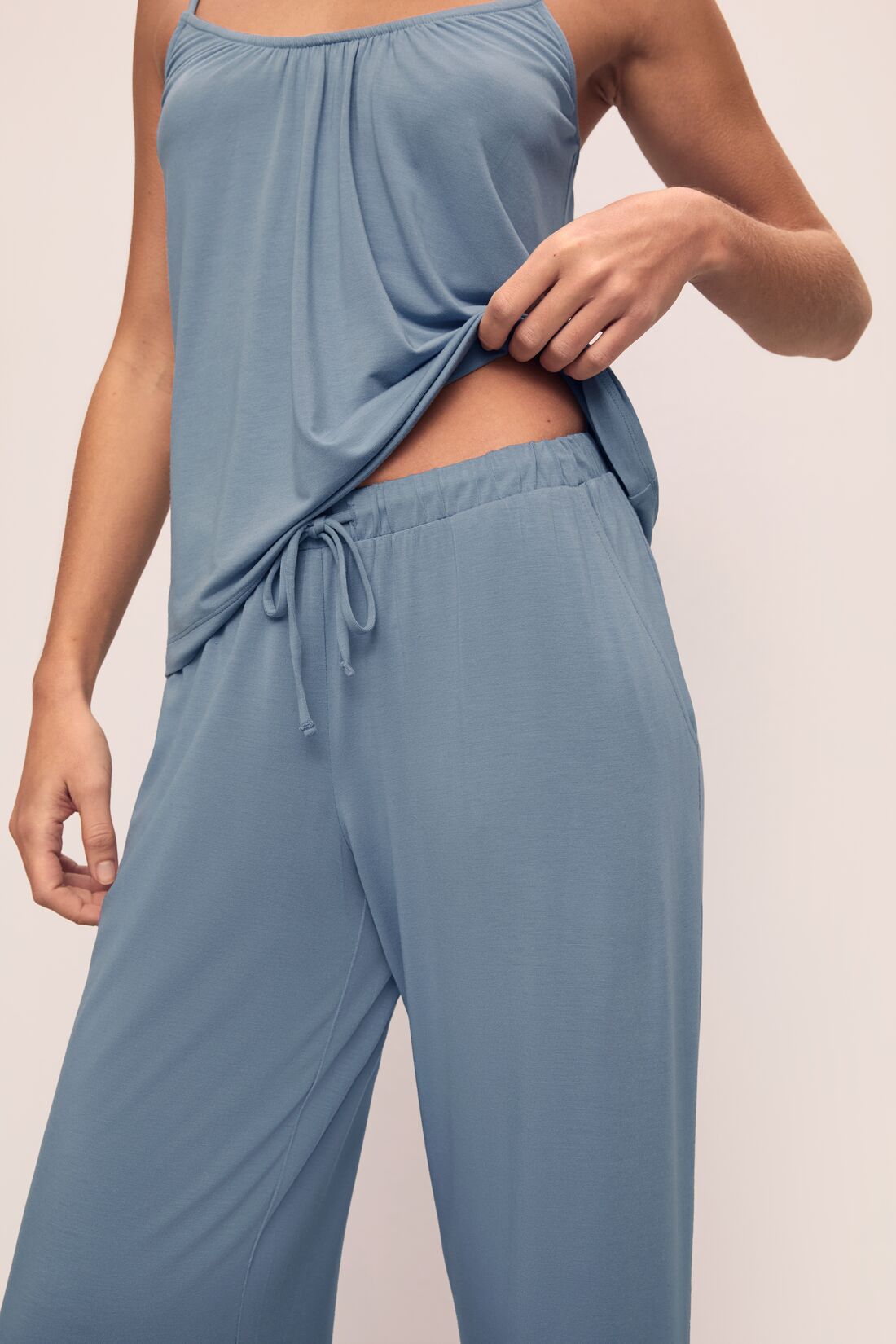 Model is wearing Gisele TENCEL Modal Cami & Pant PJ Set in Faded Denim