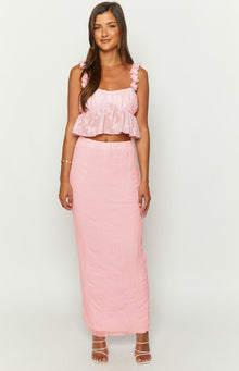 Front view of a pink square neck crop top with shirred bodice, ruffled straps, and a peplum hem in textured floral fabric