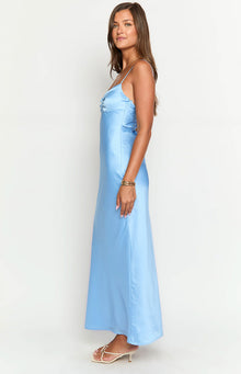Side view of a blue satin maxi dress with spaghetti straps, a gathered bust detail, and a side cutout