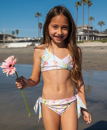 Kids Petal Gianna Bikini — light blue floral two-piece with crisscross top and oversized tie bottoms, perfect for sunny beach days.