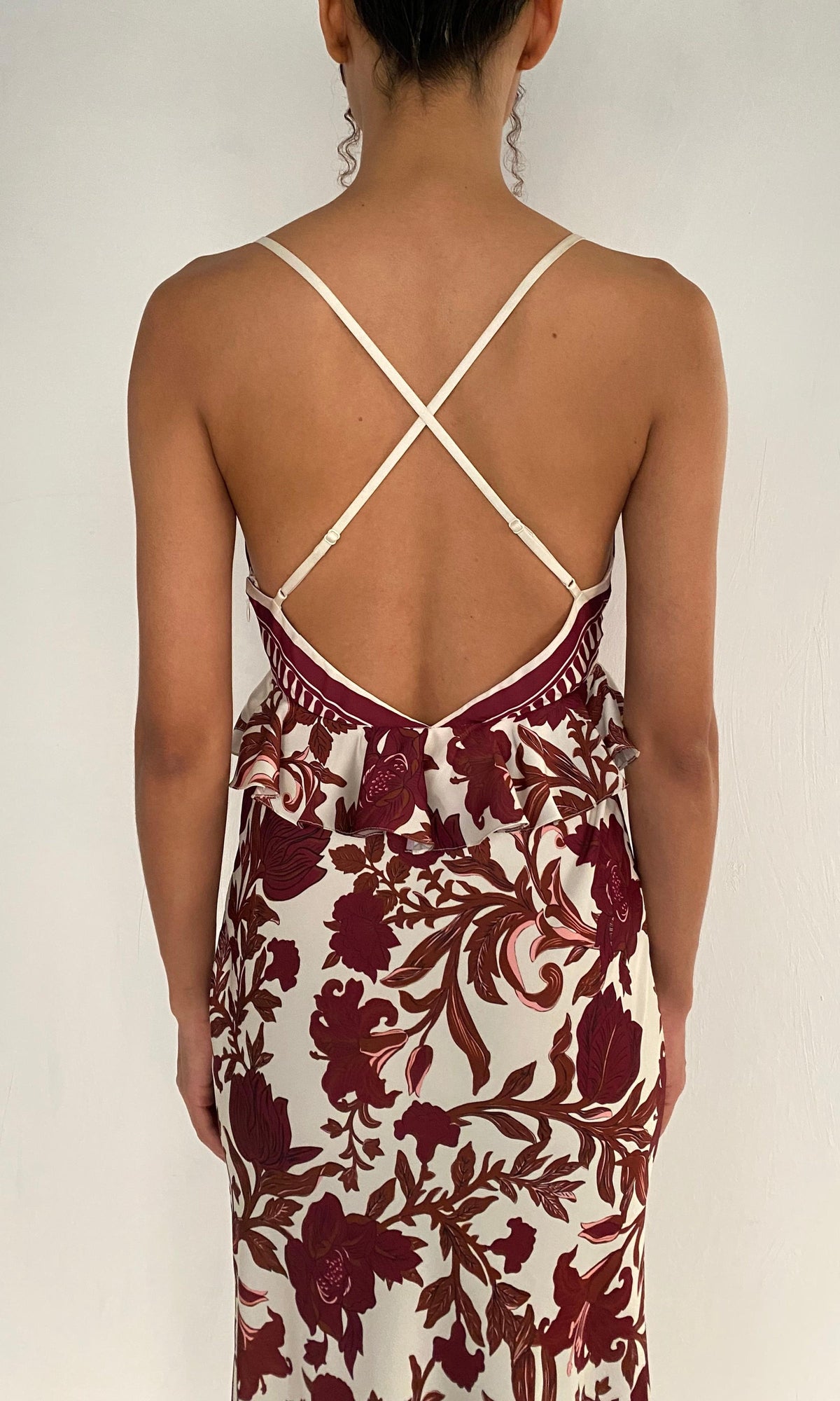 Rococo Sand | Maia Polyester Satin Lycra Cross-Back Peplum Maxi Dress | Ivory Burgundy