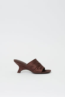 Dark brown satin mule with gathered upper, open toe, and curved heel in profile view.