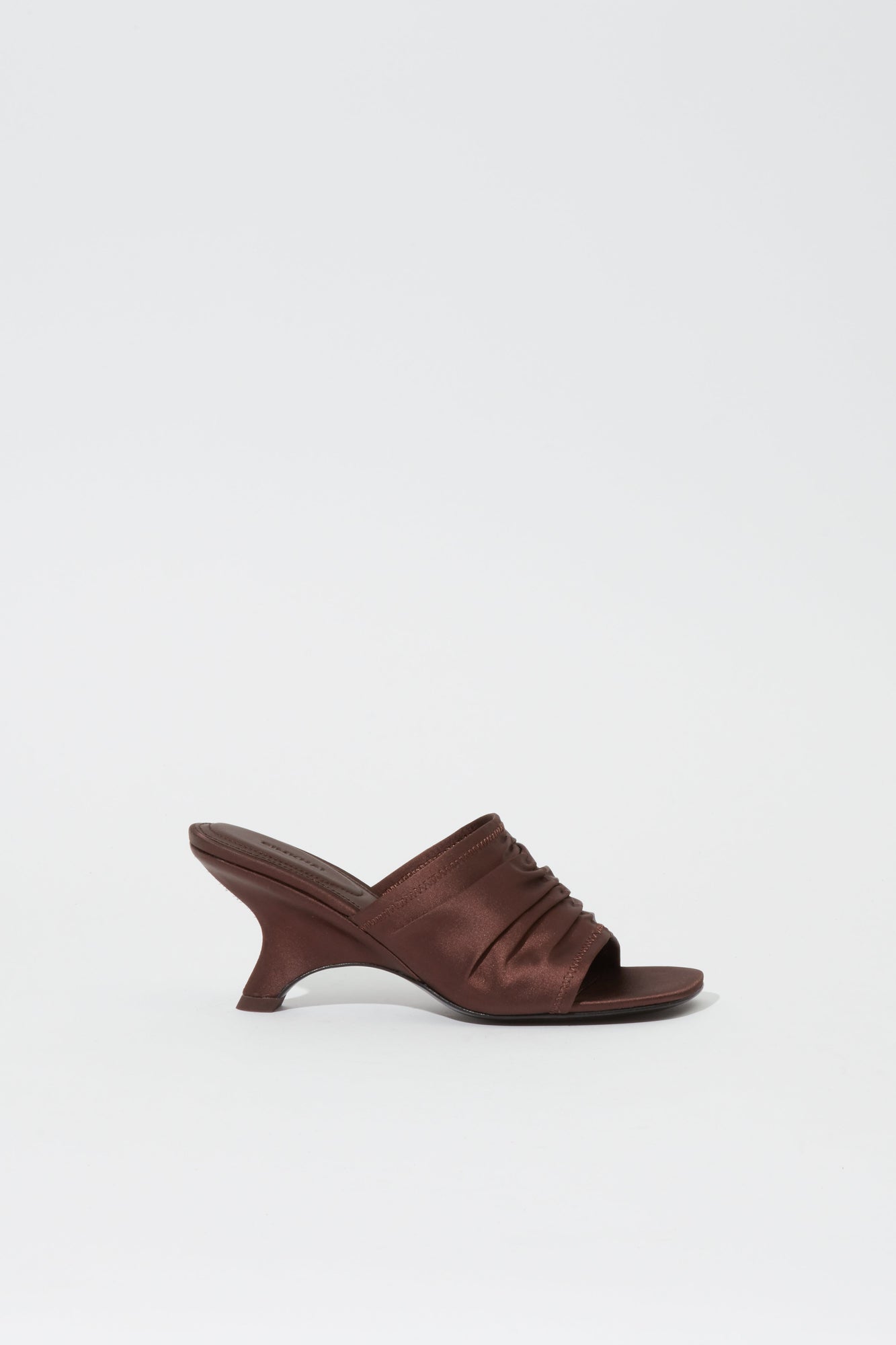 Dark brown satin mule with gathered upper, open toe, and curved heel in profile view.