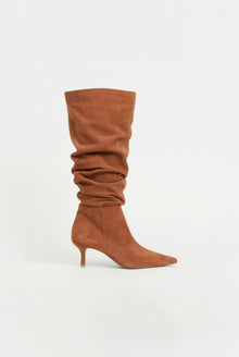 Tan suede knee-high boot with gathered shaft and thin heel, displayed against a neutral background.