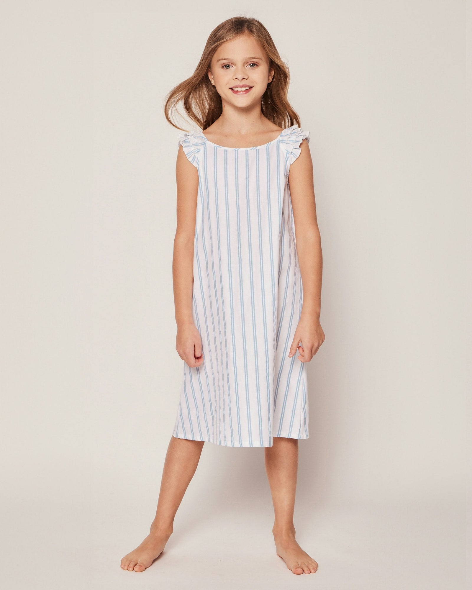 Blue and white striped dress with ruffled shoulders on a white background