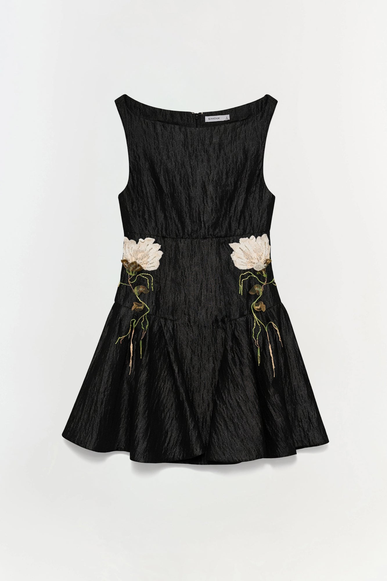 Black jacquard mini dress with white and gold floral embroidery at waist, sleeveless with boat neckline.