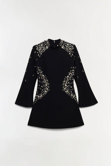 Black mini dress with crystal embellishments on shoulders and sides, flared three-quarter sleeves, and crew neckline.