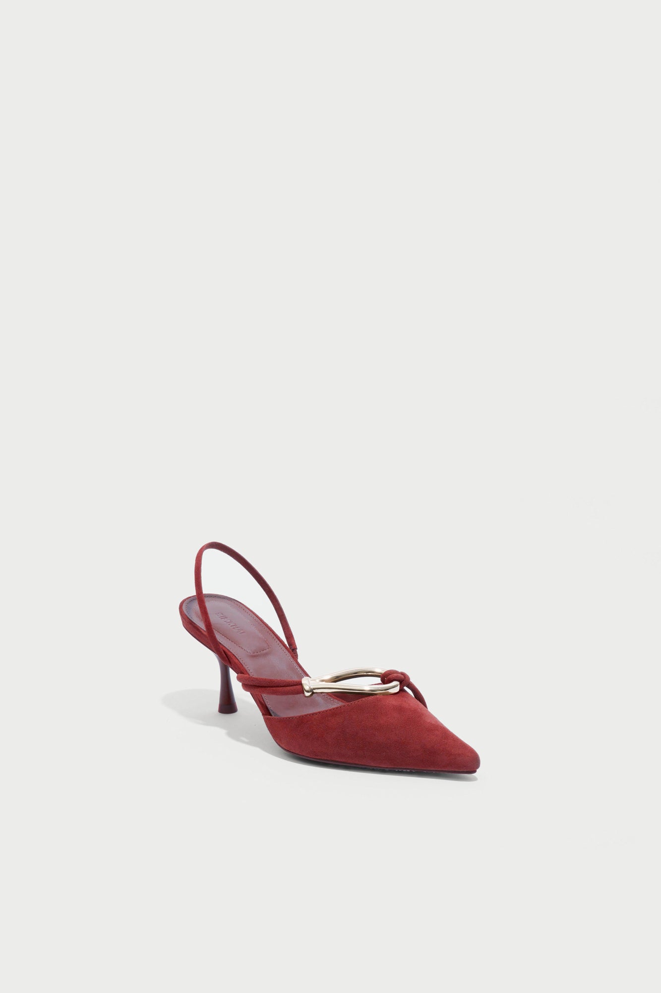 Red suede slingback heel with pointed toe and knotted strap detail across the vamp.