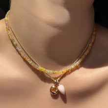Eclipse opal necklace layered with wheat chain, pink opal drop charm, citrine molten solitaire charm on the neck.