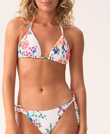 White smocked triangle bikini top with colorful floral print, featuring adjustable neck and back ties for a playful, feminine look.