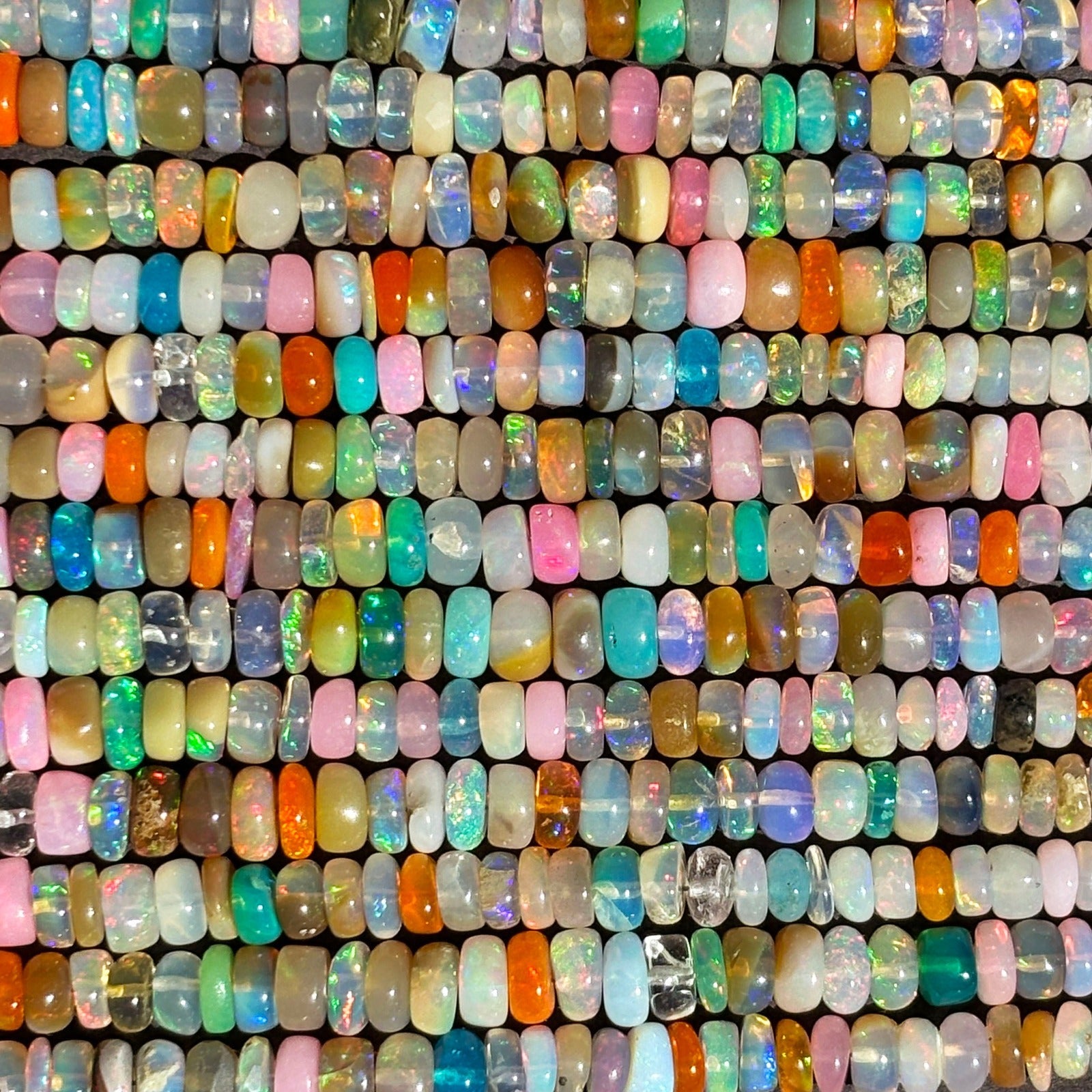 Shimmering beaded opal swatch made of smooth opal rondels in shades of white, tan, pink, orange and teal.