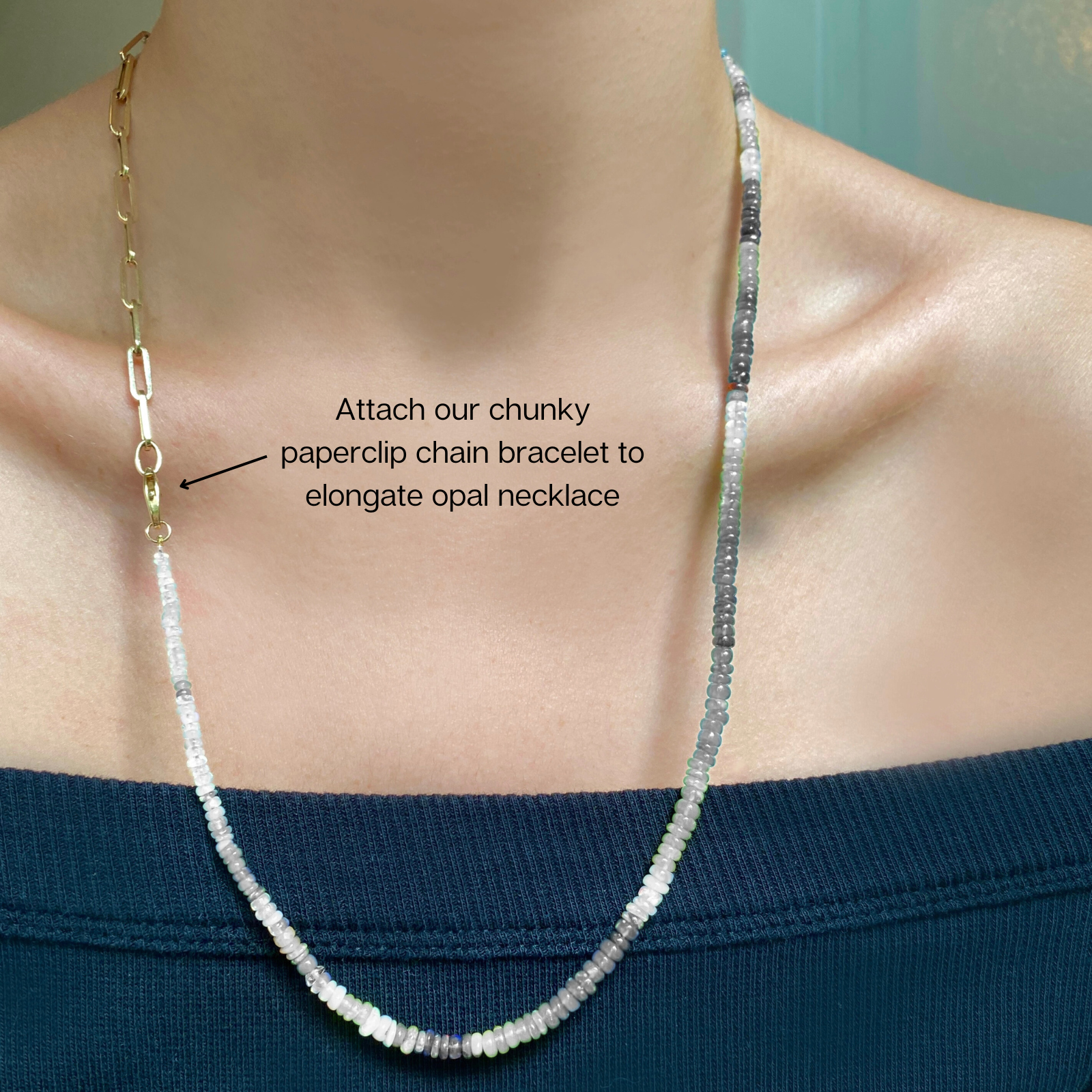 Shimmering beaded necklace made of smooth opal rondels in shades of green and black on a slim gold lobster clasp.