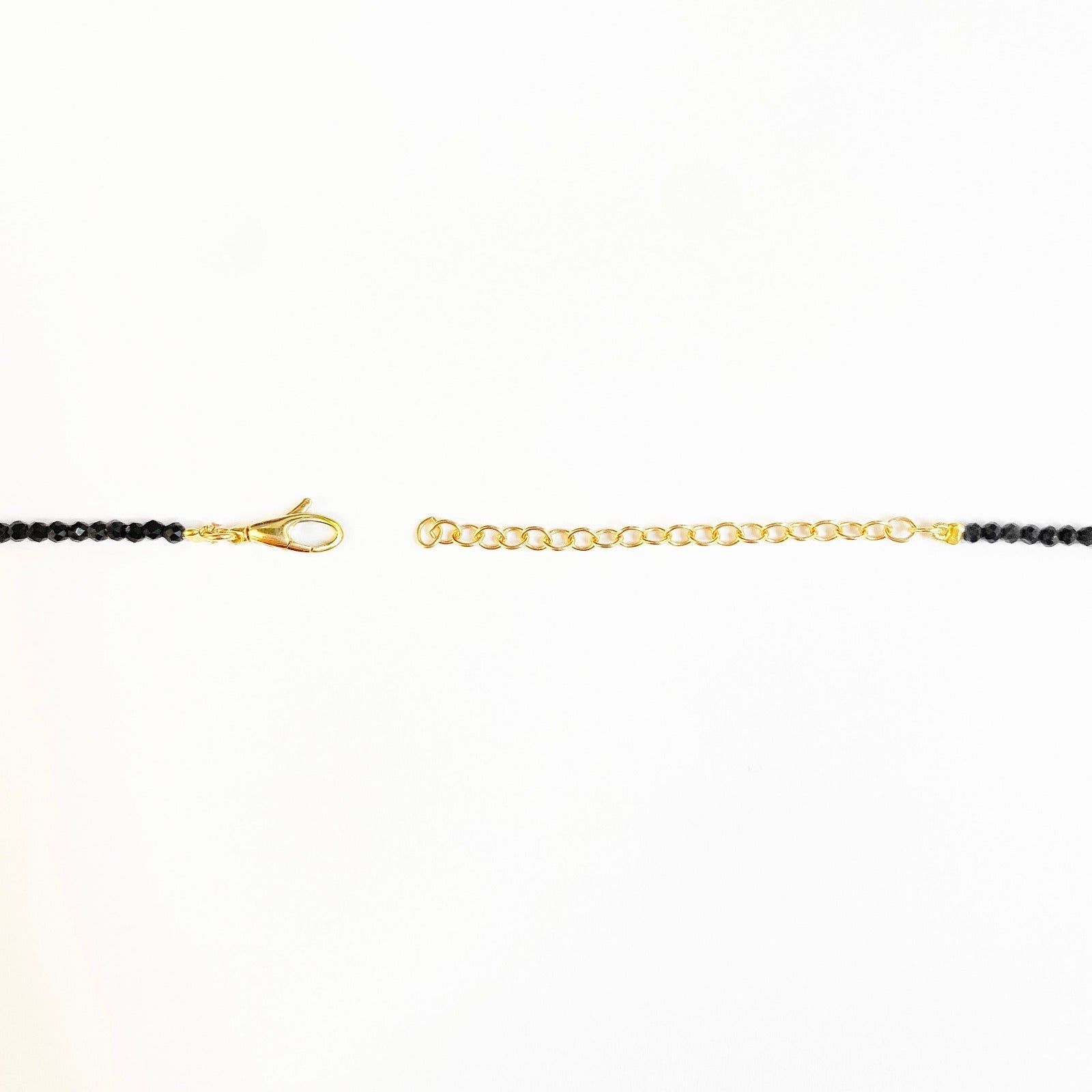 Shimmering beaded necklace made of 2.5mm faceted opals in shades of black on a gold linking lobster clasp.